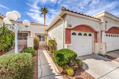 View of front of house featuring a garage, a gate,
