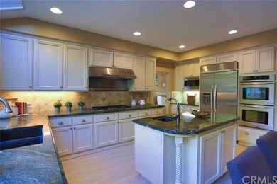 Another view of the kitchen showing double ovens, 