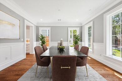 The light filled formal dining room has custom des