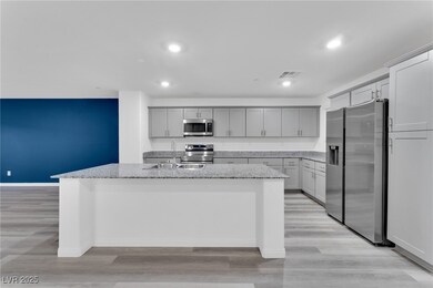 Kitchen with light stone counters, a center island