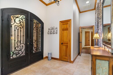 Iron front doors lead into entryway.