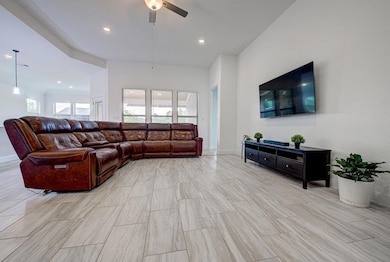 Living area with ceiling fan and recessed lighting
