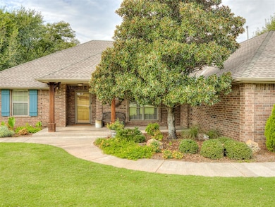 Single story home with roof with shingles, brick siding, and a porch