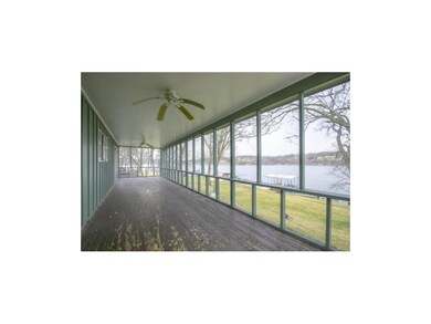 Screened porch shaded by trees