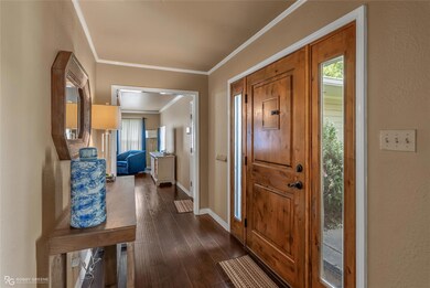 Entryway featuring dark wood-type flooring and orn