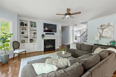 Family room features hardwood floors, a gas firepl