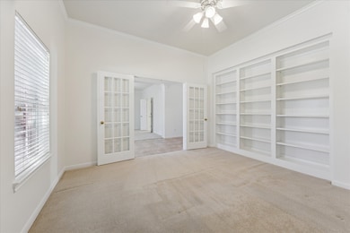 Study/home office (13x12) with wall of bookshelves. Nice sized window on the left that views the front yard. Ceiling fan above.