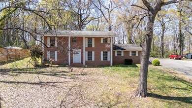 Neoclassical home with brick siding, a front yard,