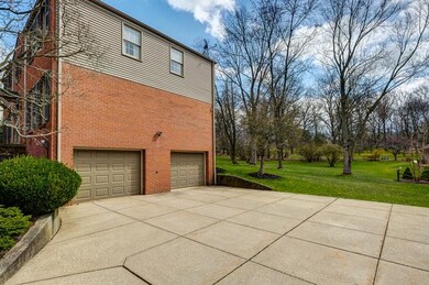 The large flat concrete driveway leads to the spac