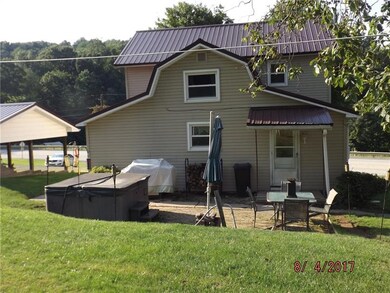 Rear of home has space for grilling or a hot tub .