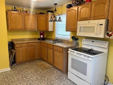 Kitchen with pendant lighting, white appliances, o