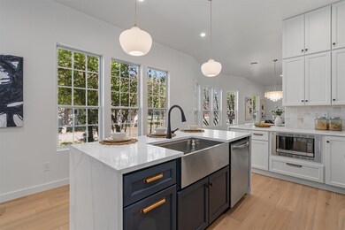 Kitchen with stainless steel appliances, white ca