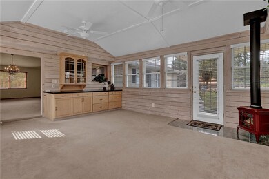 Family room lined with windows and custom blinds,