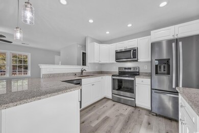 Kitchen featuring white cabinets, appliances with 