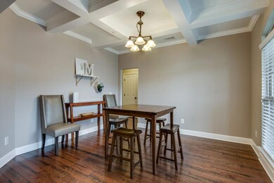 The dining room features a coffered ceiling and easy access to the kitchen and butler's pantry.