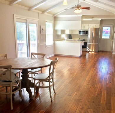 Open floor plan with hardwood and tile throughout. 