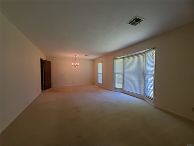 Formal living and dining rooms with bay window