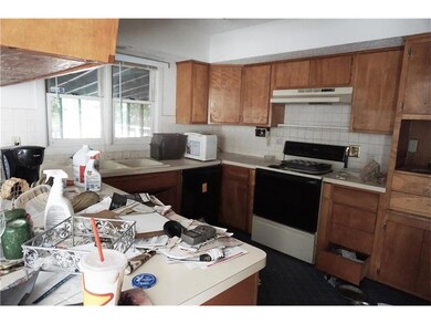 KITCHEN WITH WINDOWS TO THE BACK OF THE HOME.
