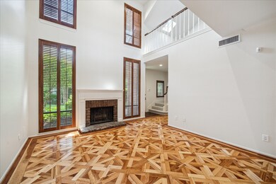 Dramatic living room with 20-foot ceilings, gas fi