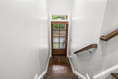 Doorway to outside with wood finished floors and stairs