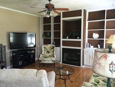 Family room comes with hardwood, gas fireplace and built-in book shelves