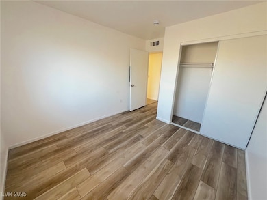 Unfurnished bedroom featuring light wood-type floo