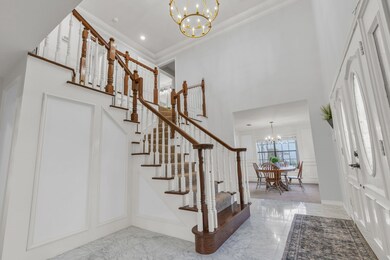 Light and bright foyer brings in TONS of natural light. This view leads into the formal dining room.