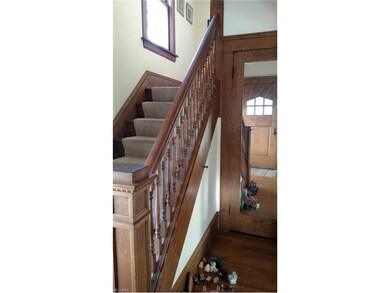 The mirrored door is a walk-in foyer coat closet.