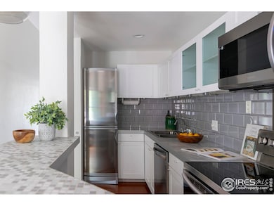 Stainless appliances, glass tile and marble counters