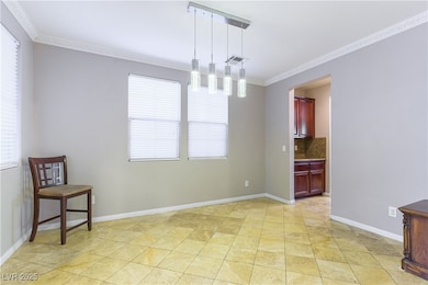 Unfurnished dining area with crown molding and bas