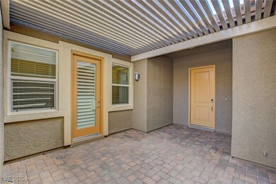 Property entrance with stucco siding and a covered