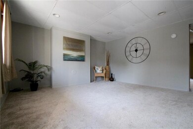 Large living room has recessed lighting and brand 