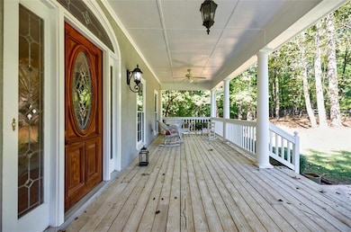 Wooden deck with covered porch and ceiling fan