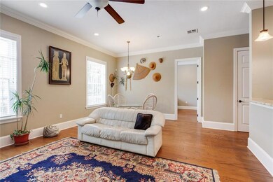Light-filled great room has recessed lighting and