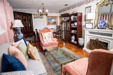Living room featuring a chandelier and a textured ceiling