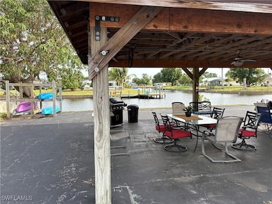 View of patio with a water view and grilling area
