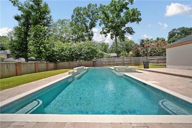 View of pool with a fenced backyard, a patio, and a pool with connected hot tub