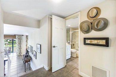 Hall featuring light tile patterned flooring