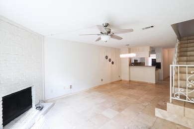 Unfurnished living room featuring a brick fireplac