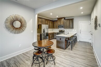 Kitchen featuring a kitchen breakfast bar, light w