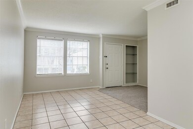 Tiled spare room with ornamental molding