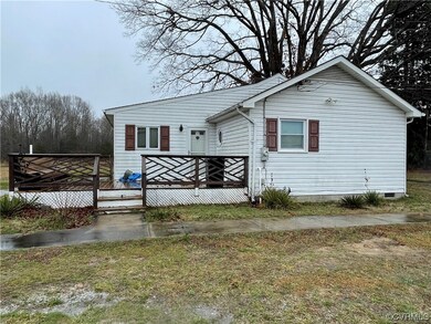 View of front of house featuring a wooden deck