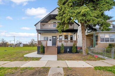 View of front of property with covered porch, a balcony, and a gate