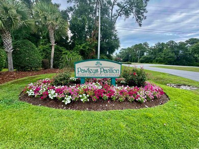 Community / neighborhood sign with a yard