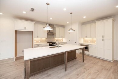This kitchen is actually as large as it looks and the oversized island can seat approx. 4 comfortably  Pictures represent a previously built home, not the actual home.