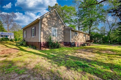 View of side of property with a yard and central A
