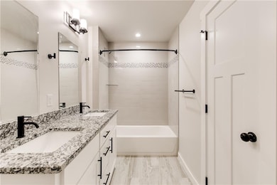 Primary bathroom features double sinks, matte blac