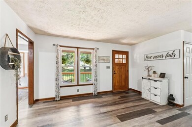 Foyer with wood finished floors and a textured ceiling
