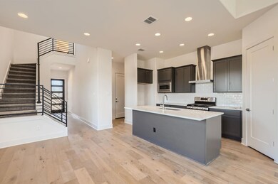 Kitchen with wall chimney range hood, stainless s