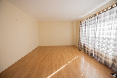 Empty room featuring light wood-style flooring and baseboards